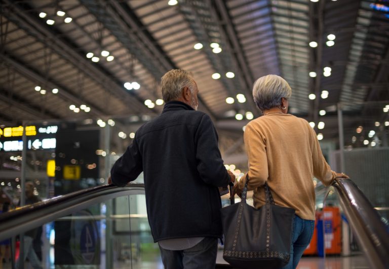 2 personnes utilisent des escalators dans une gare ferroviaire - accessibilité trains mobilité